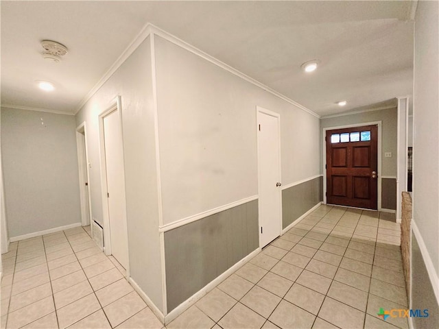 tiled entryway featuring ornamental molding