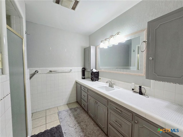 bathroom featuring vanity, tile walls, and tile patterned floors