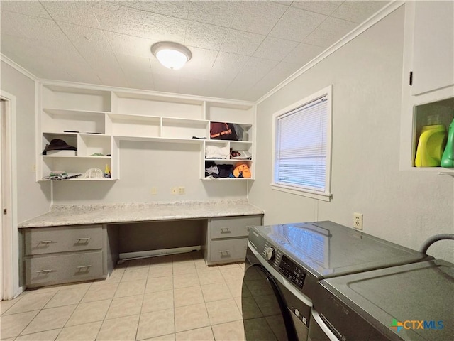 interior space featuring light tile patterned floors, ornamental molding, and washing machine and clothes dryer