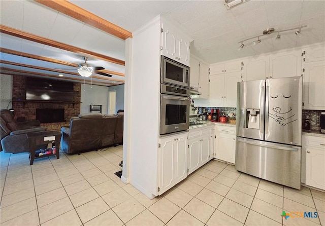 kitchen with white cabinetry, stainless steel appliances, and tasteful backsplash