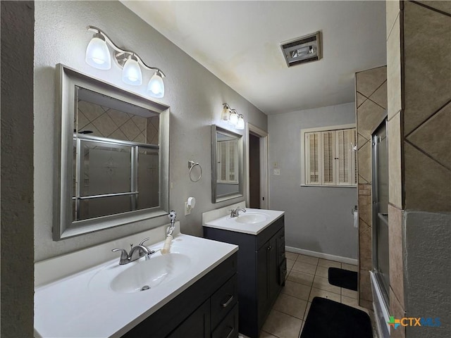 bathroom featuring enclosed tub / shower combo, tile patterned floors, and vanity