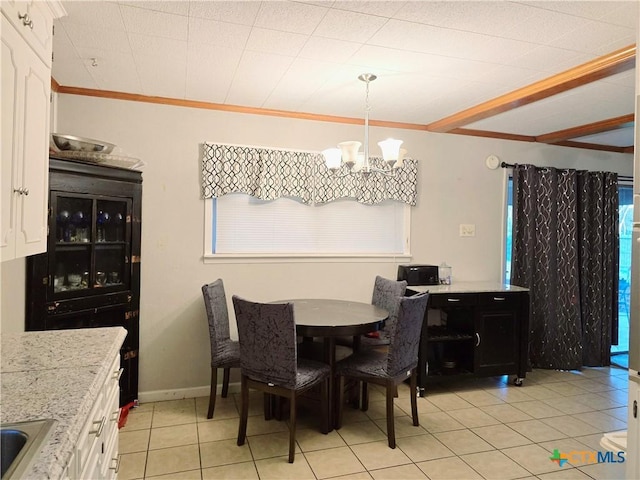 dining room featuring crown molding, a chandelier, and light tile patterned floors