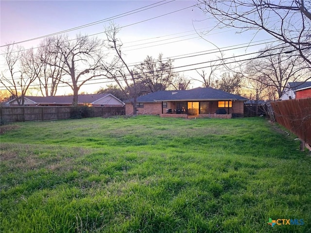 view of yard at dusk