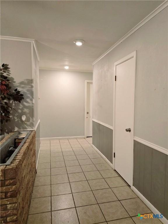 interior space featuring ornamental molding and light tile patterned floors