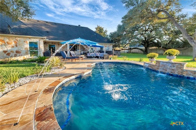 view of swimming pool with fence, a lawn, and a patio