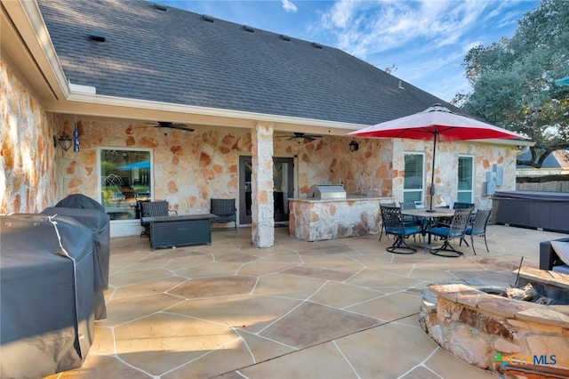 view of patio / terrace featuring outdoor dining area, ceiling fan, and an outdoor kitchen