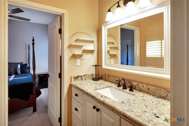 ensuite bathroom with ensuite bathroom, ceiling fan, and vanity