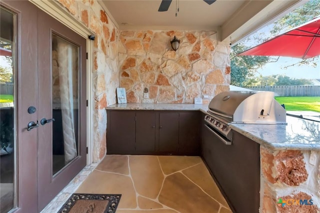 view of patio / terrace with exterior kitchen, ceiling fan, and grilling area