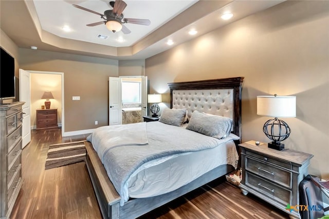 bedroom featuring recessed lighting, a raised ceiling, visible vents, dark wood-type flooring, and baseboards