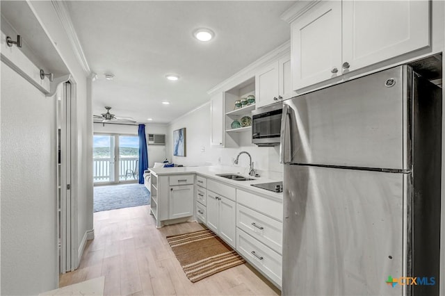 2 Cliffhouse Dr Unit 113, Belton, TX 76513 - kitchen with stainless steel appliances, a sink, open shelves, light wood-style floors, and white cabinetry