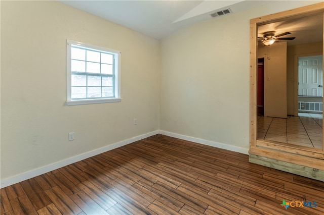 unfurnished room with dark hardwood / wood-style flooring and ceiling fan