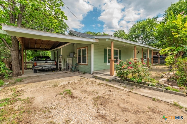 single story home with a porch and a carport