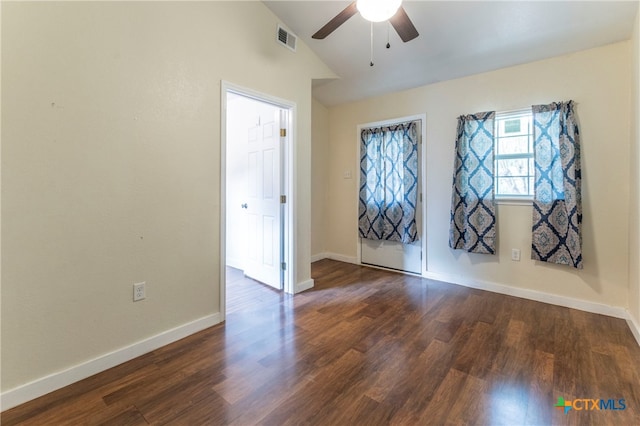 spare room featuring ceiling fan, dark wood-type flooring, and lofted ceiling