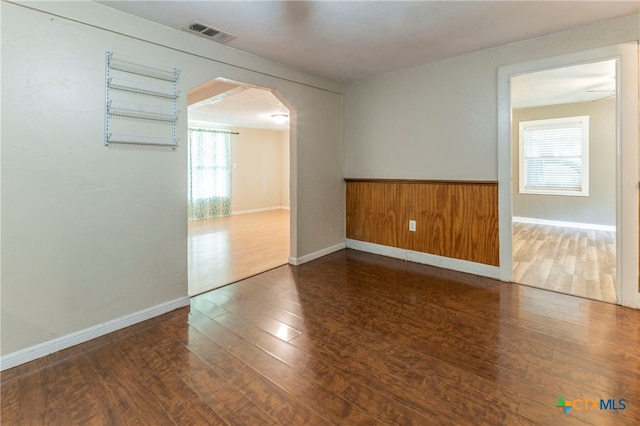 unfurnished room with dark hardwood / wood-style flooring