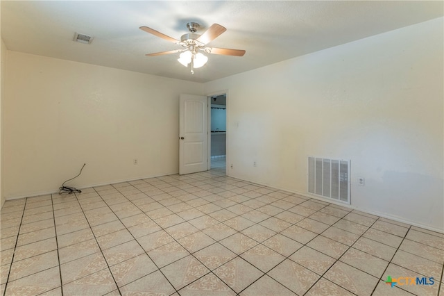 tiled empty room featuring ceiling fan