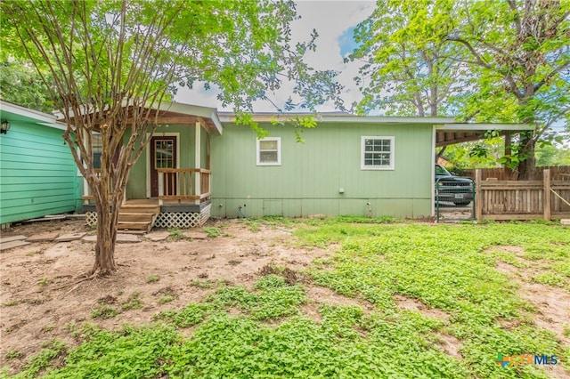 back of house with a carport