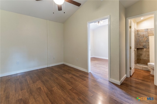 empty room featuring a fireplace, dark wood-type flooring, ceiling fan, and lofted ceiling