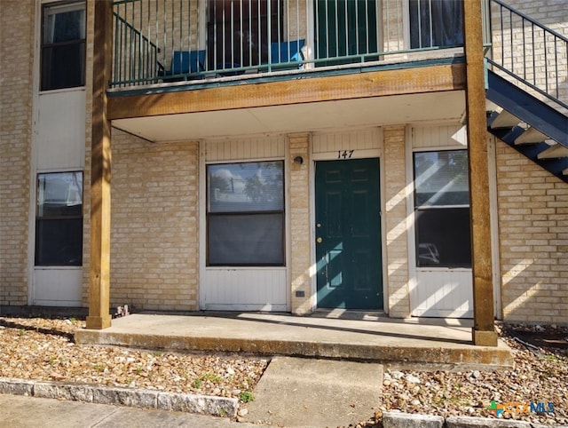 doorway to property featuring a balcony