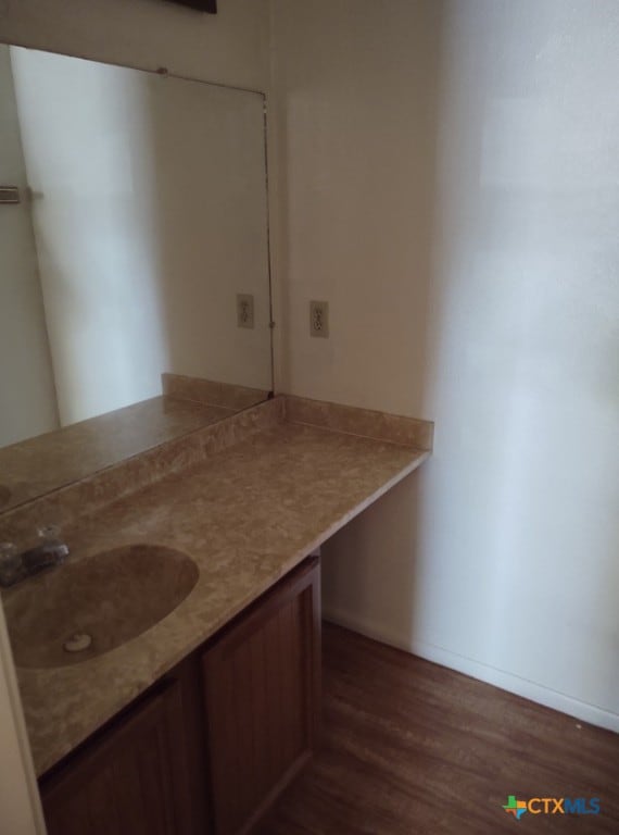 bathroom featuring vanity and hardwood / wood-style floors