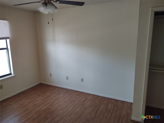 unfurnished bedroom featuring hardwood / wood-style flooring, ceiling fan, and a textured ceiling