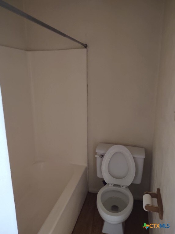 bathroom with a bath and toilet