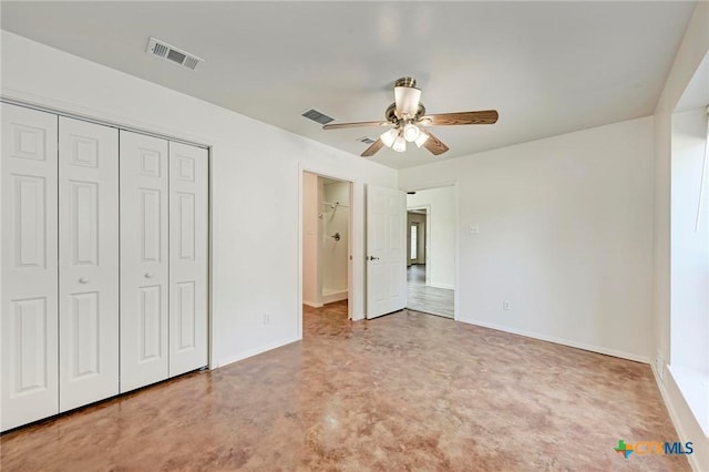 unfurnished bedroom with concrete flooring, ceiling fan, and a closet