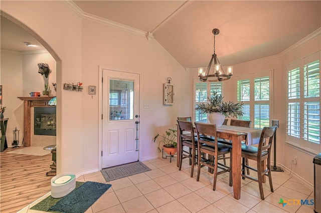 1521 Shadow Canyon Dr, Temple, TX 76502 - dining space featuring arched walkways, plenty of natural light, a chandelier, light tile patterned flooring, and ornamental molding