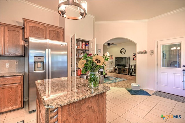 1521 Shadow Canyon Dr, Temple, TX 76502 - kitchen with stainless steel refrigerator with ice dispenser, light tile patterned floors, ornamental molding, a ceiling fan, and light stone countertops