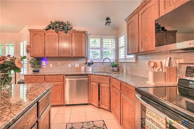 1521 Shadow Canyon Dr, Temple, TX 76502 - kitchen featuring appliances with stainless steel finishes, backsplash, light tile patterned floors, light stone counters, and lofted ceiling