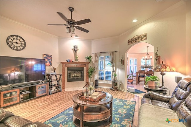 1521 Shadow Canyon Dr, Temple, TX 76502 - living room with ceiling fan, arched walkways, wood finished floors, a chandelier, and ornamental molding