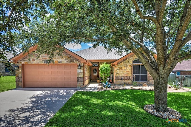 1521 Shadow Canyon Dr, Temple, TX 76502 - view of front of house featuring stone siding, an attached garage, driveway, and a shingled roof