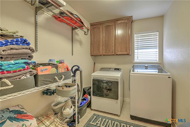 1521 Shadow Canyon Dr, Temple, TX 76502 - laundry area featuring independent washer and dryer, cabinet space, and light tile patterned floors
