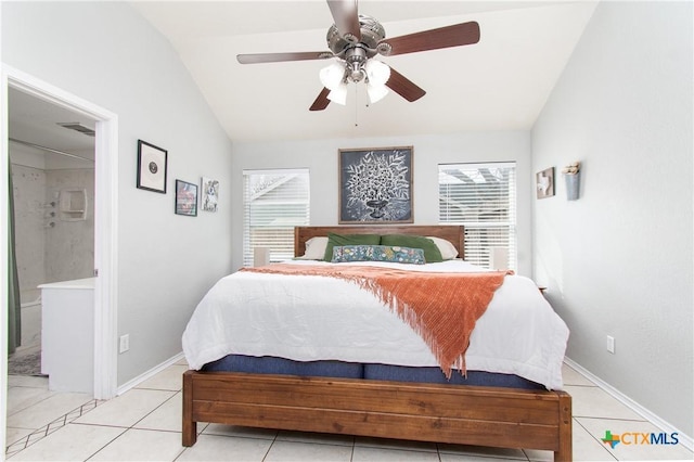 bedroom with ceiling fan, multiple windows, connected bathroom, and vaulted ceiling