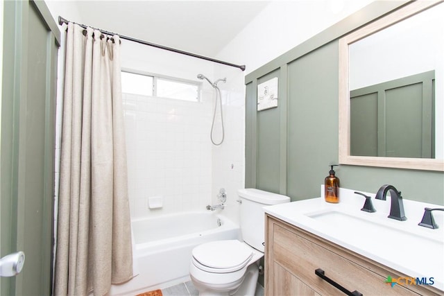 full bathroom featuring toilet, vanity, and shower / tub combo with curtain