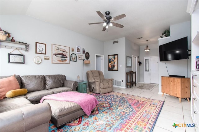 living room with lofted ceiling, ceiling fan, and light tile patterned flooring