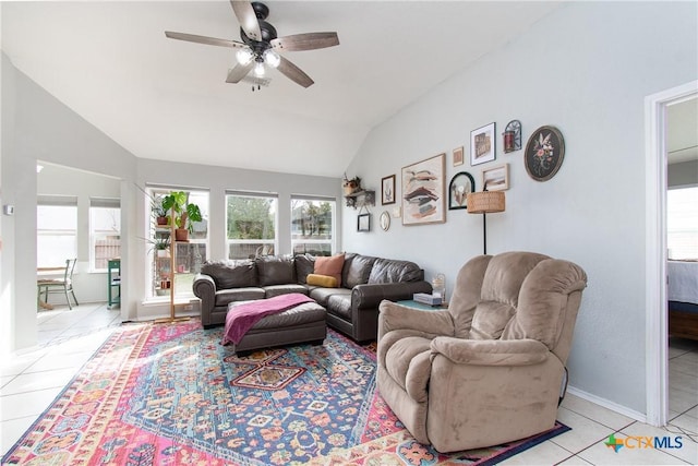 tiled living room with ceiling fan and vaulted ceiling