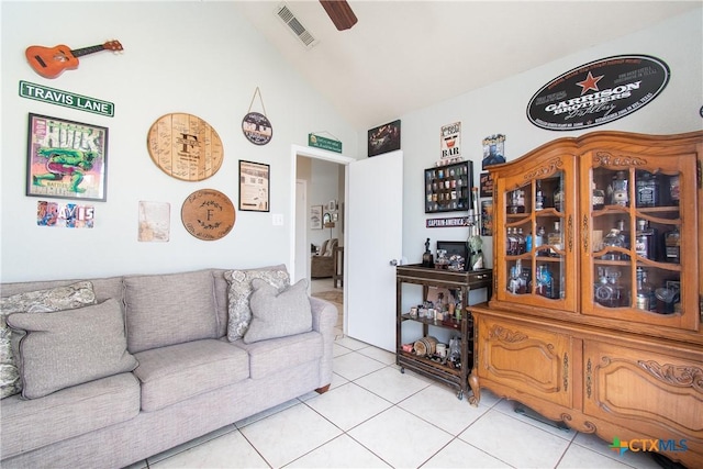 living room with vaulted ceiling and light tile patterned flooring