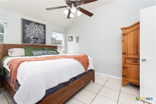 bedroom featuring vaulted ceiling, light tile patterned flooring, and ceiling fan