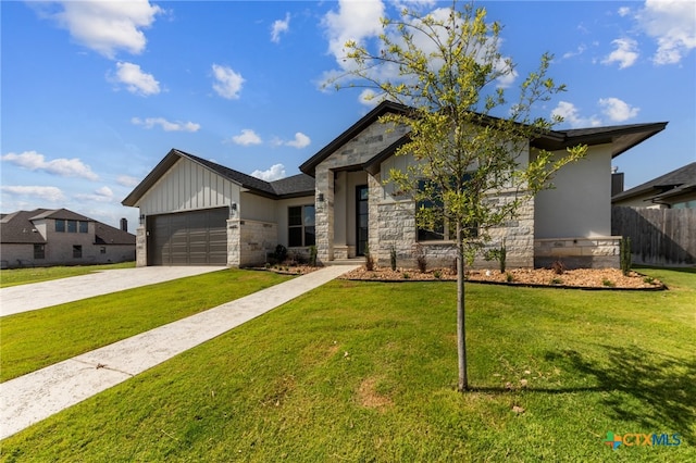 view of front of home with a garage and a front lawn