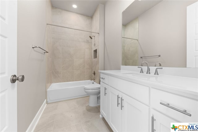 full bathroom with vanity, tile patterned flooring, toilet, and tiled shower / bath combo