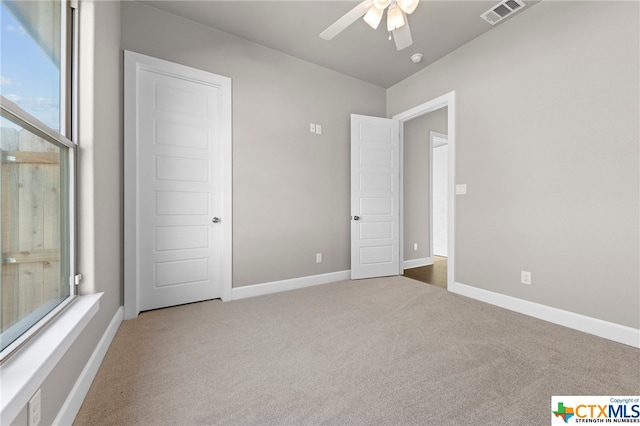 unfurnished bedroom with ceiling fan and carpet flooring