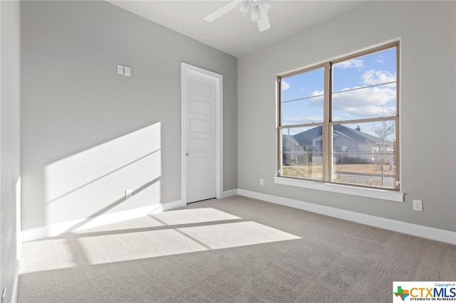 interior space with light carpet and ceiling fan