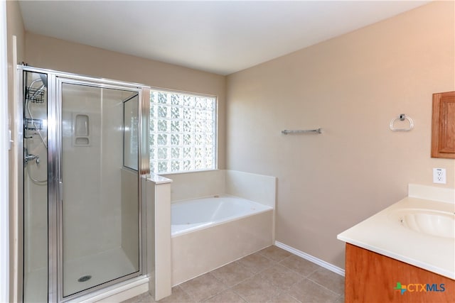 bathroom featuring shower with separate bathtub, vanity, and tile patterned floors