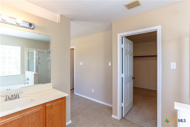 bathroom with shower with separate bathtub, tile patterned floors, and vanity