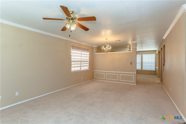 empty room featuring light colored carpet, a textured ceiling, ceiling fan with notable chandelier, and ornamental molding