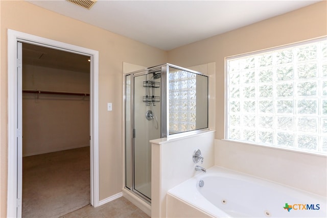 bathroom with shower with separate bathtub, tile patterned floors, and a healthy amount of sunlight