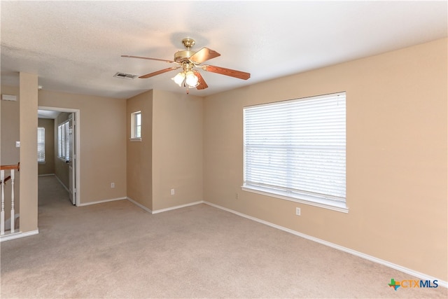 spare room with light carpet and ceiling fan