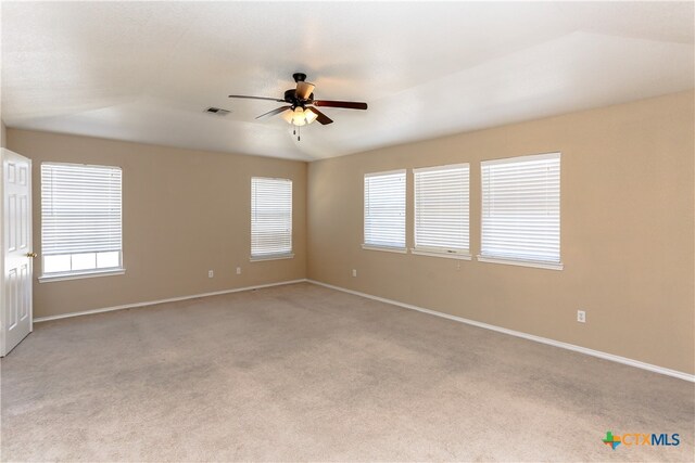 spare room with light colored carpet and ceiling fan