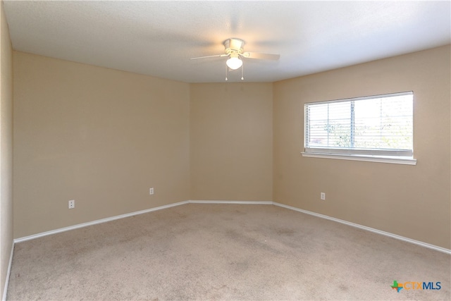 unfurnished room with ceiling fan and light colored carpet