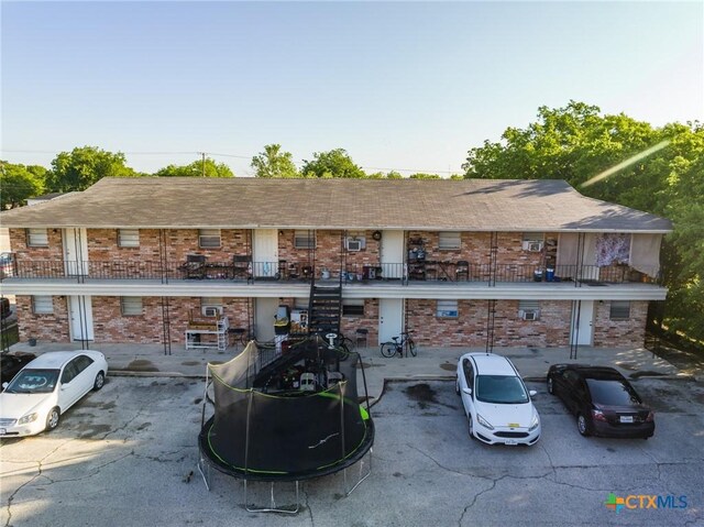 1203 Urbantke Ct Unit A-H, Copperas Cove, TX 76522 - rear view of house with brick siding, stairs, and a balcony